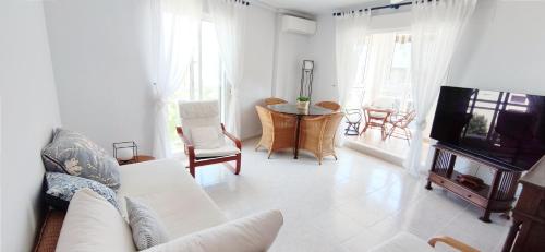 a living room with a couch and a tv at Apartamento Dianium by DENIA COSTA in Denia