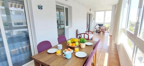 a table with a bowl of fruit on it in a room at Apartamento Dianium by DENIA COSTA in Denia