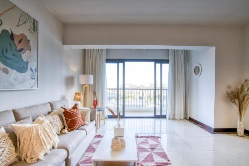 a living room with a couch and a table at LOFTS by Elegant Hospitality in Cairo