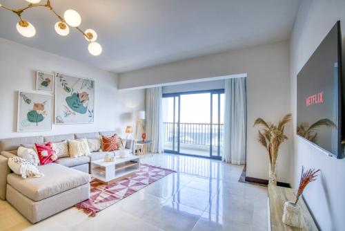 a living room with a couch and a tv at LOFTS by Elegant Hospitality in Cairo