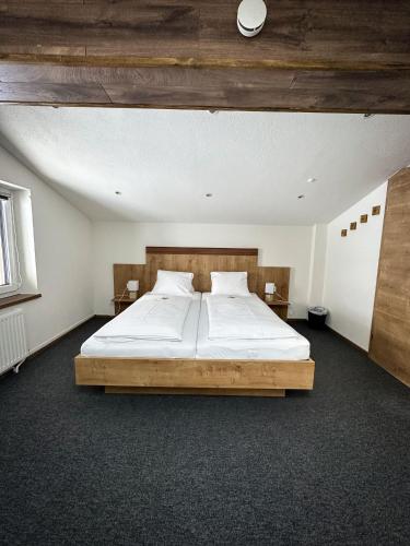 a bedroom with a large bed in a room at Frühstückspension Auer - Haus Kargl in Schladming