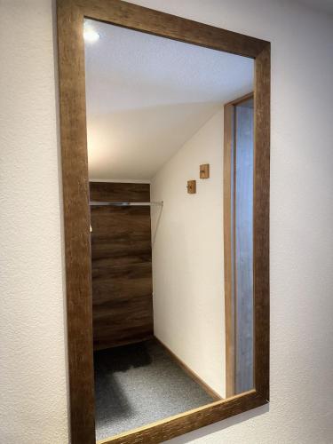 a mirror on the wall of a room with a closet at Frühstückspension Auer - Haus Kargl in Schladming