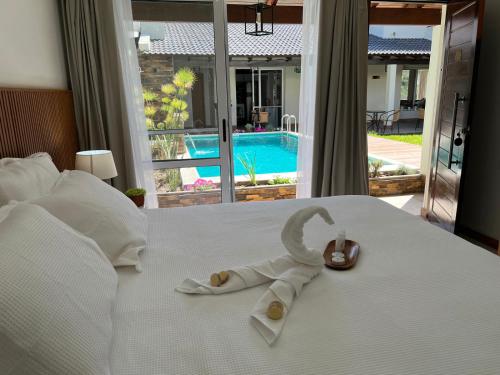 a childs robe and a pair of shoes on a bed at HAS Hotel Boutique in Bella Unión
