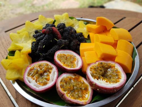 a plate of fruit and vegetables on a table at Villa Noina Glamping in Ban Nong Takhain