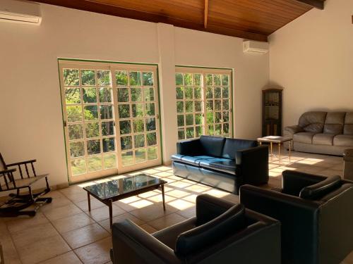a living room with a couch and a table at Pousada Primavera in São Luiz do Paraitinga