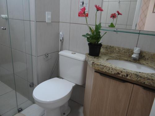 a bathroom with a toilet and a sink at Ocean Atlantic Praia de Iracema in Fortaleza