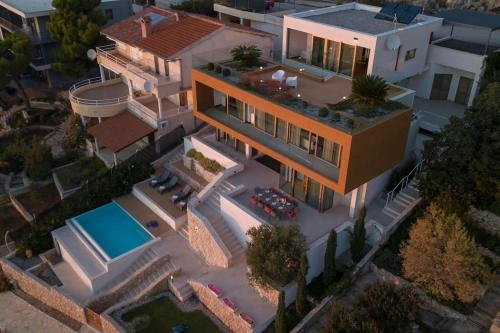 an overhead view of a house with a swimming pool at Villa Gloss Primosten in Primošten