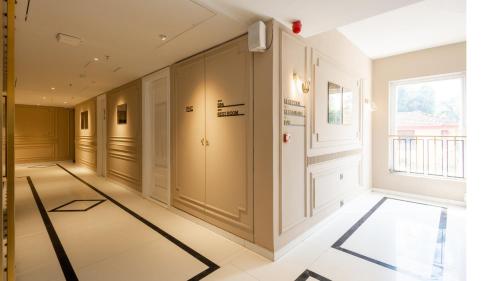 a hallway with white walls and a large window at Renest Calangute Goa in Calangute