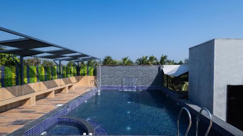 a swimming pool on a roof of a house at Renest Calangute Goa in Calangute