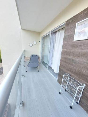 a balcony with a chair and a wall at Residence Vibe Dominicus 308 in Bayahibe