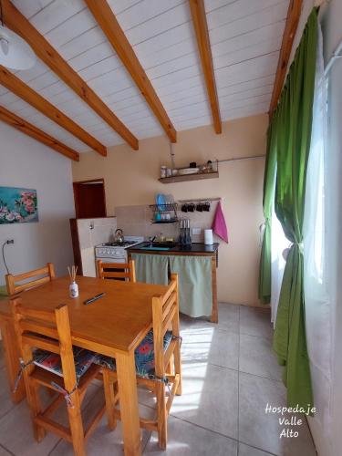 a kitchen with a wooden table and chairs in a room at Hospedaje Valle Alto in San Martín de los Andes