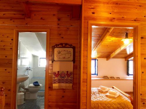 a bedroom with a bed and a bathroom with a toilet at Estelle in Khalkíon