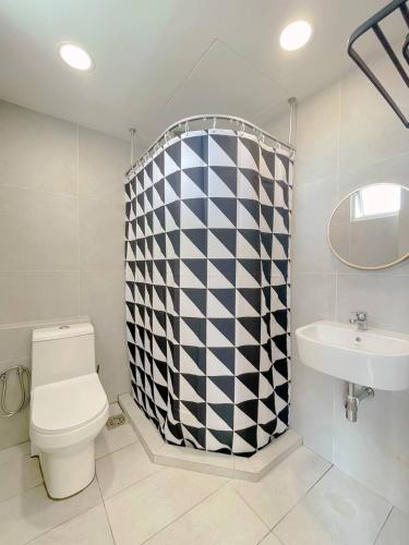 a bathroom with a toilet and a sink at QUEENSLAND SUITES at Aru Suites, Kota Kinabalu in Kota Kinabalu