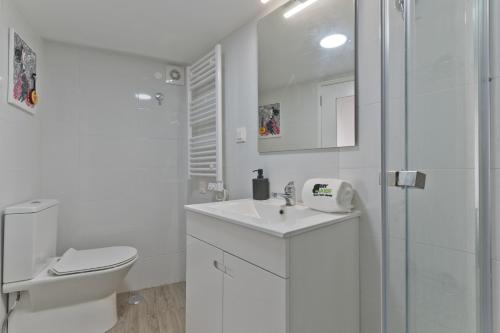 uma casa de banho branca com um WC e um lavatório em BmyGuest - Alfama River Studio em Lisboa