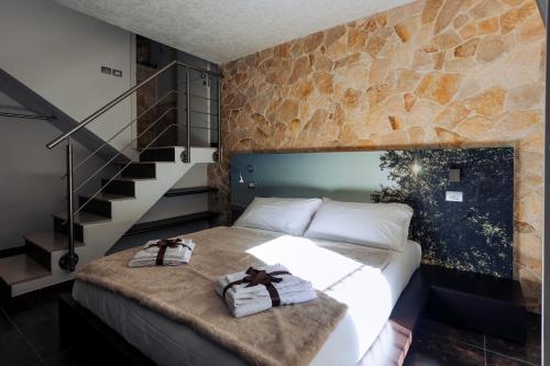 a bedroom with a bed with two towels on it at A Casa Di Grazia in Ragusa