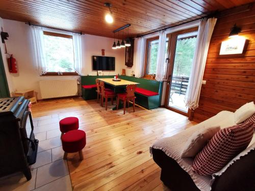 a living room with a couch and a table in it at Chalet Via Mons in Mojstrana