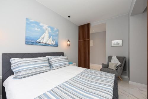 a bedroom with a bed with a sailboat painting on the wall at Sea Organ Paradise Zadar in Zadar