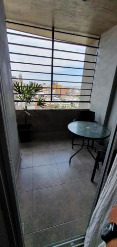 a view of a room with a table and a window at Salta 5 - Bon Repos in San Miguel de Tucumán
