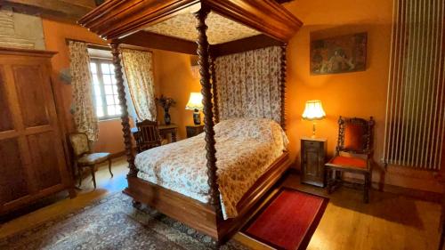 a bedroom with a canopy bed in a room at Maison Familiale au cœur de Saint Gervais in Saint-Gervais-dʼAuvergne