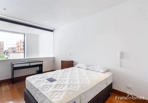1 dormitorio con cama grande y ventana grande en FH - Dazzling apartment in Virrey park - Bogota, en Bogotá