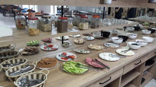 a buffet with plates of food on a table at Bolu Deluxe Otel in Bolu