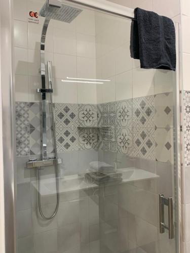 a shower with a glass door in a bathroom at APP202 Proche Disneyland Lagny sur Marne in Lagny