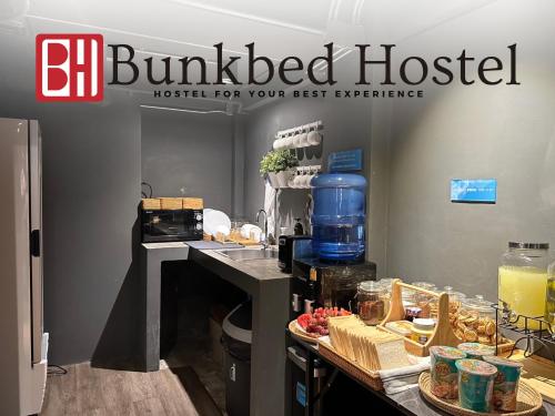 a buffedacistacist sign with food on a counter at Bunkbed Hostel in Makkasan