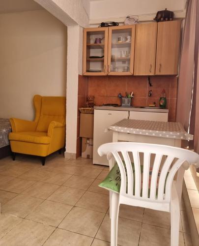 a kitchen with a table and a chair in a room at Kamenovo sea in Budva