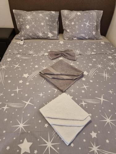 a bed with stars on it with a comforter at Kamenovo sea in Budva