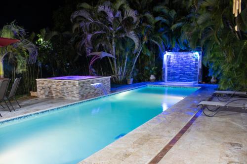 a swimming pool with blue lights in a resort at Casa Linda beautiful Villa in Sosúa