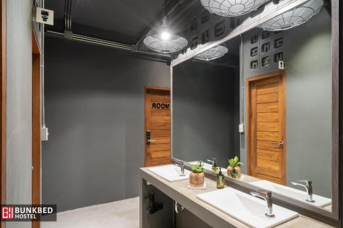 a bathroom with two sinks and a large mirror at Bunkbed Hostel in Makkasan