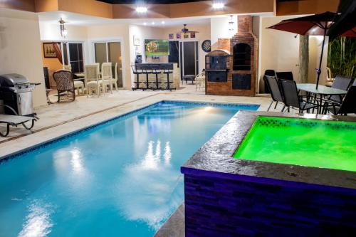 a swimming pool in a house with a table and chairs at Casa Linda beautiful Villa in Sosúa