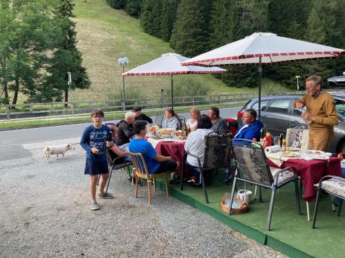 a group of people sitting at a table at a restaurant at Gästehaus Christophorus in Innerkrems