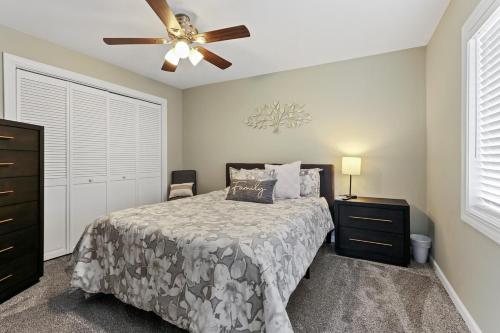 a bedroom with a bed and a ceiling fan at Cottage By David Rigney Real Estate Solutions in Lake Geneva