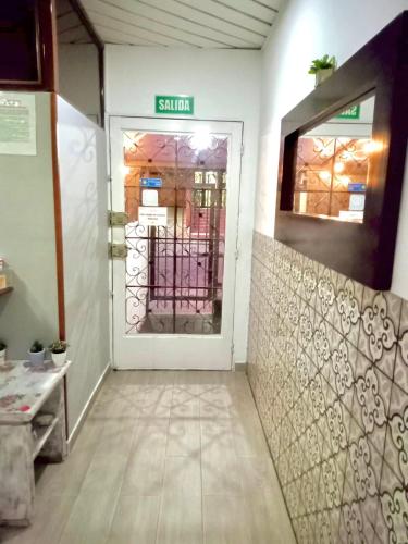 a front door of a store with a sign on it at Hotel Maceo 55 - Colonial Inn in Bogotá