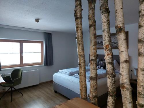 a bedroom with a bed and some trees at Apartment Rainer - mittendrin in Söll