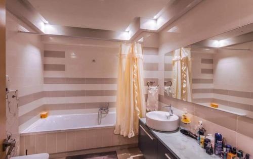 a bathroom with a sink and a bath tub at Villa Fotaki in Kos