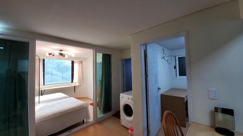 a small bedroom with a bed and a window at Seoul Tower Ville in Seoul