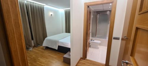 a bathroom with a bed and a toilet in a room at Port Blau Cambrils in Cambrils