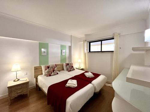 a bedroom with a large bed and a window at Vilamoura Marina Mar 1 with Pool by Homing in Vilamoura