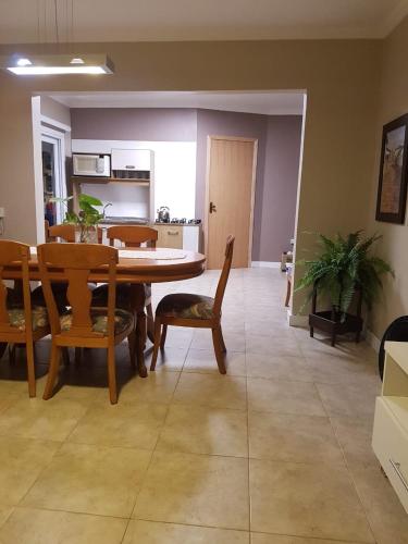 a living room with a dining room table and chairs at KIKO in Tramandaí