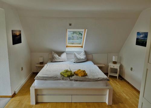 a white bed in a room with a window at Waldhufenhaus in Schöna in Reinhardtsdorf