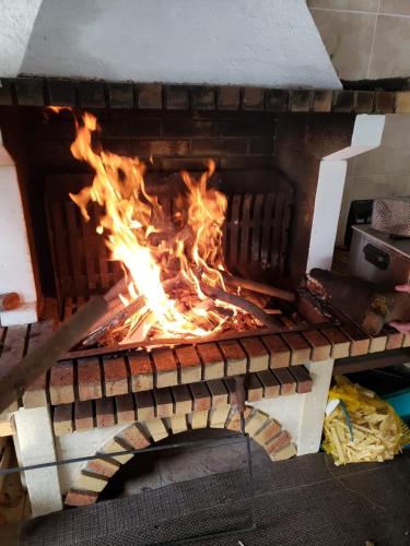 a fire is cooking in a pizza oven at LE CLOS DU TULIPIER in La Chapelle-du-Bard