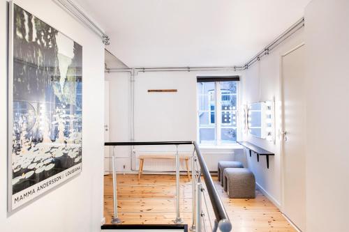 a staircase in a room with a poster on the wall at The Townhouse by Daniel&Jacob's in Copenhagen
