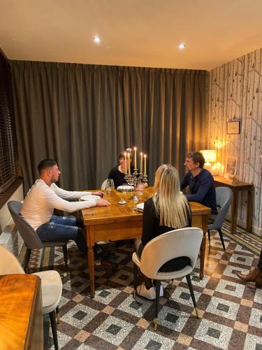 a group of people sitting around a table at LE CLOS DU TULIPIER in La Chapelle-du-Bard