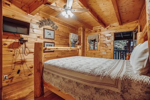 a bedroom with a bed in a log cabin at Sugar Bear Cabin in Sevierville