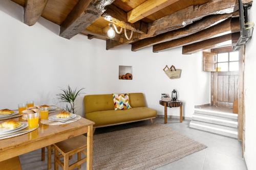 a living room with a table and a couch at Moinho do Sr. Arnaldo in Atouguia da Baleia