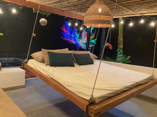 a bed swing in a room with a colorful wall at Hacienda Daniela 