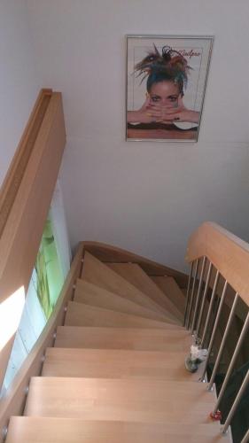 a staircase with a picture of a woman on the wall at Ferienwohnung im bayerischen Wald in Tittling
