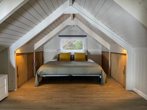 a bedroom with a bed in an attic at Charme à Graide in Graide
